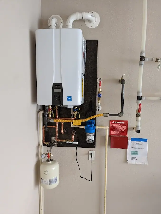 Professional plumber installing copper piping in a West Park home